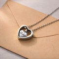 Rhodium heart urn cremation necklace on kraft envelope, name engraved on inner heart pendant