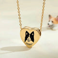 18k gold pet photo heart urn necklace close-up showing hand-drawn portrait engraving with blurred corgi in background