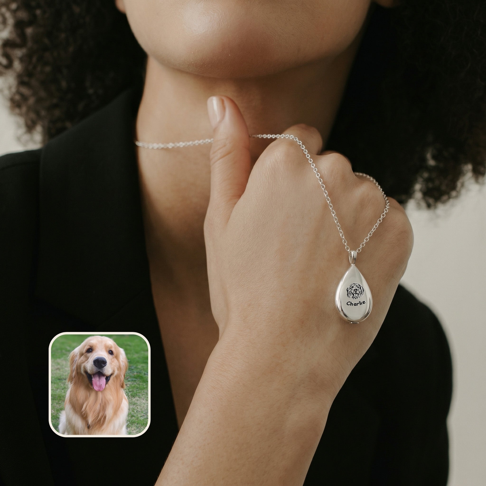 Silver teardrop pet urn necklace with portrait engraving in warm gold tones, lifestyle composition