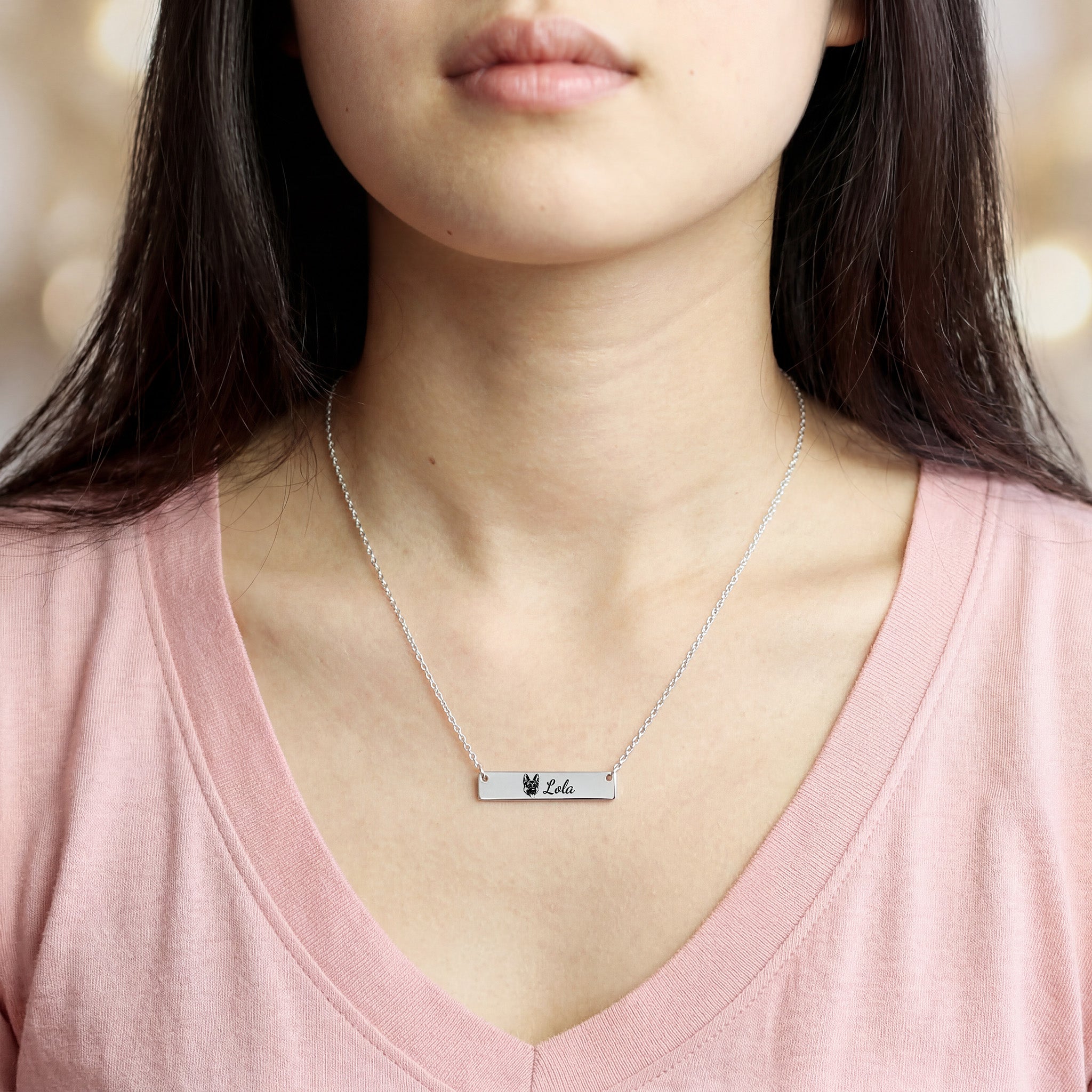 Woman wearing silver pet portrait bar necklace with engraved portrait and name Lola