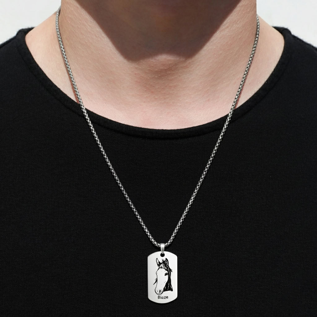 Person wearing silver pet portrait dog tag pendant necklace over black shirt, lifestyle close-up