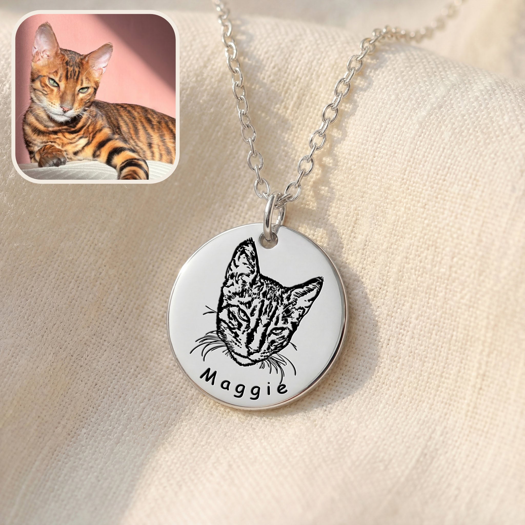 Silver disc pendant necklace with hand-drawn cat portrait engraving on soft fabric
