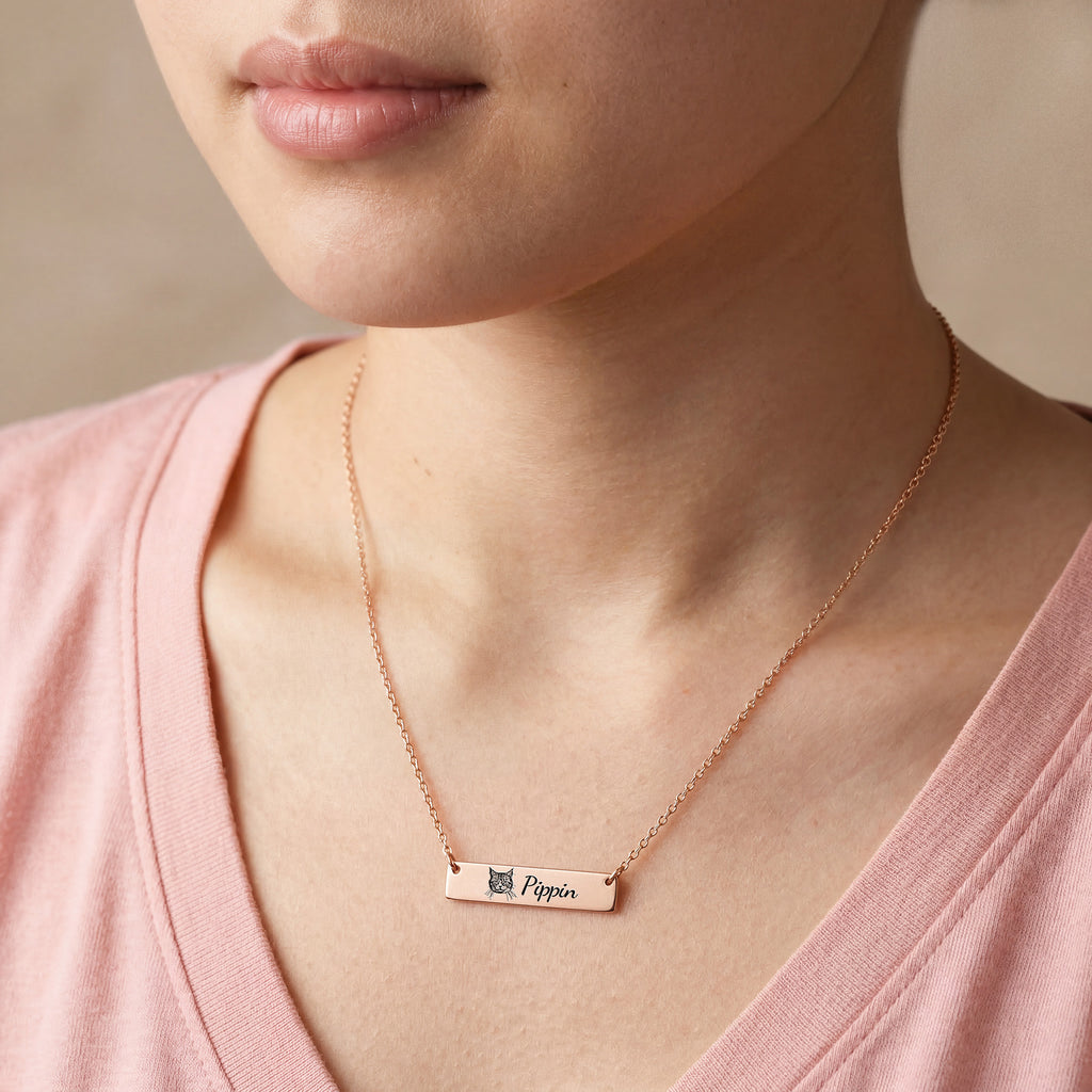 Woman wearing rose gold pet portrait bar necklace with engraved cat portrait and name Pippin