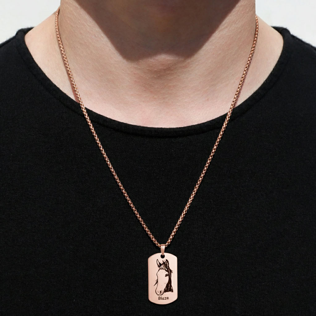 Person wearing rose gold pet portrait dog tag pendant necklace over black shirt, lifestyle view
