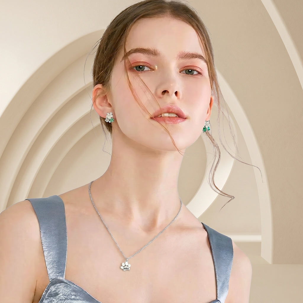 Model wearing silver paw print necklace with single engraved pendant