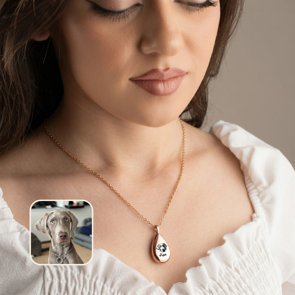 Rose gold teardrop pet photo urn necklace with hand-drawn dog portrait held in hand with inset pet photo