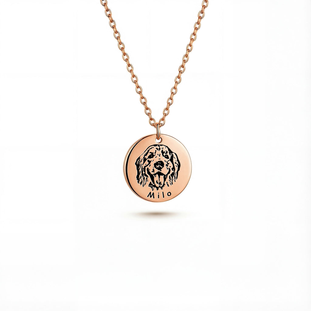 Rose gold pet face disc pendant with portrait engraving on white background, close-up
