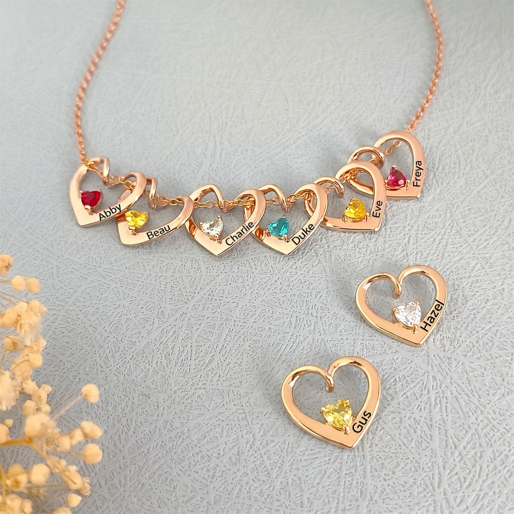 Eight rose gold heart birthstone pendants displayed as full multi-pet family set