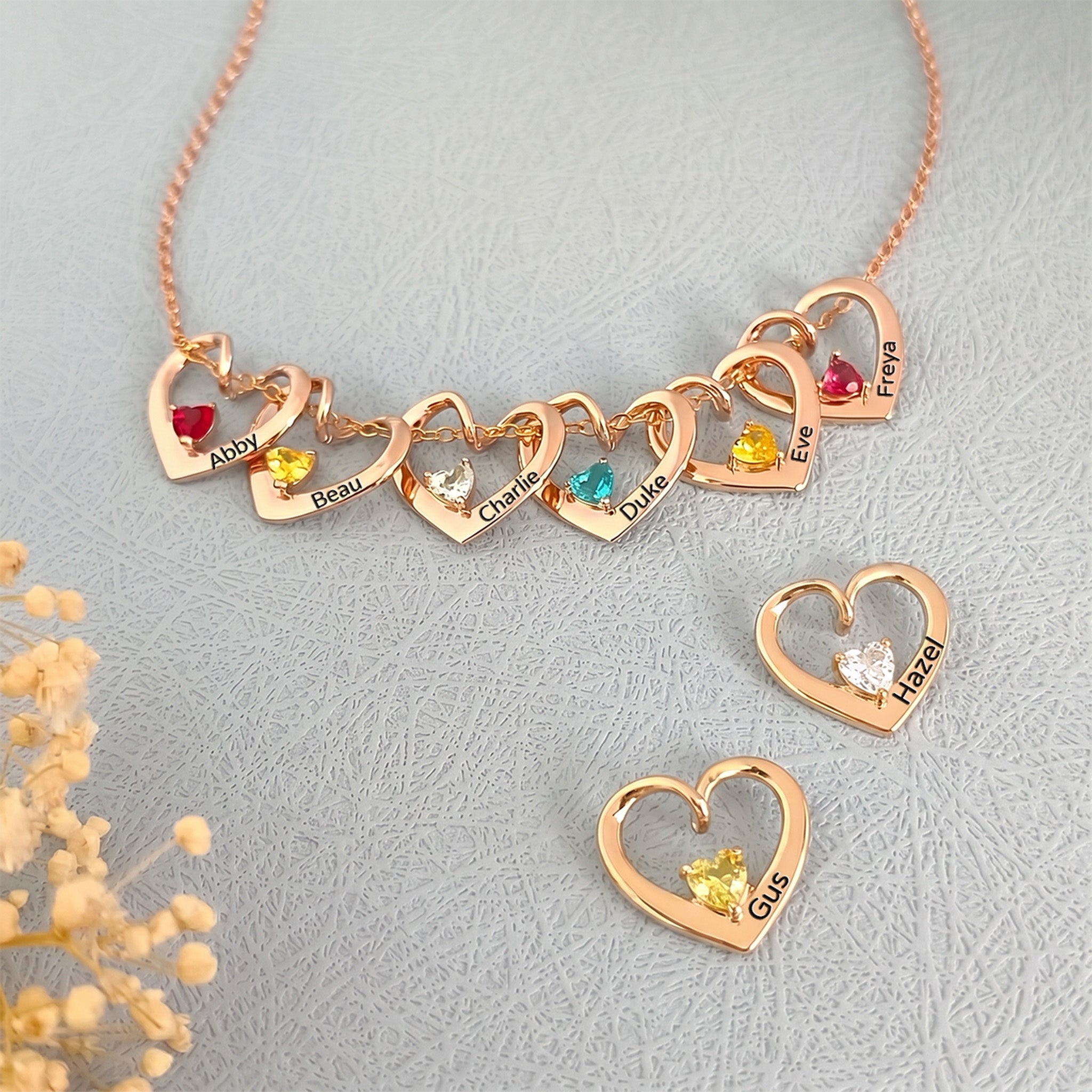 Eight rose gold heart birthstone pendants displayed as full multi-pet family set