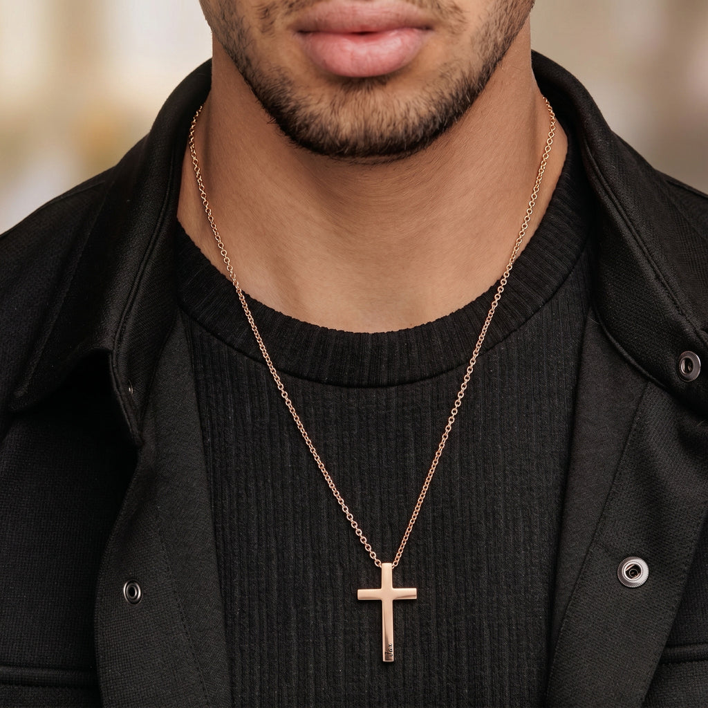 Man wearing rose gold cross necklace with engraved name