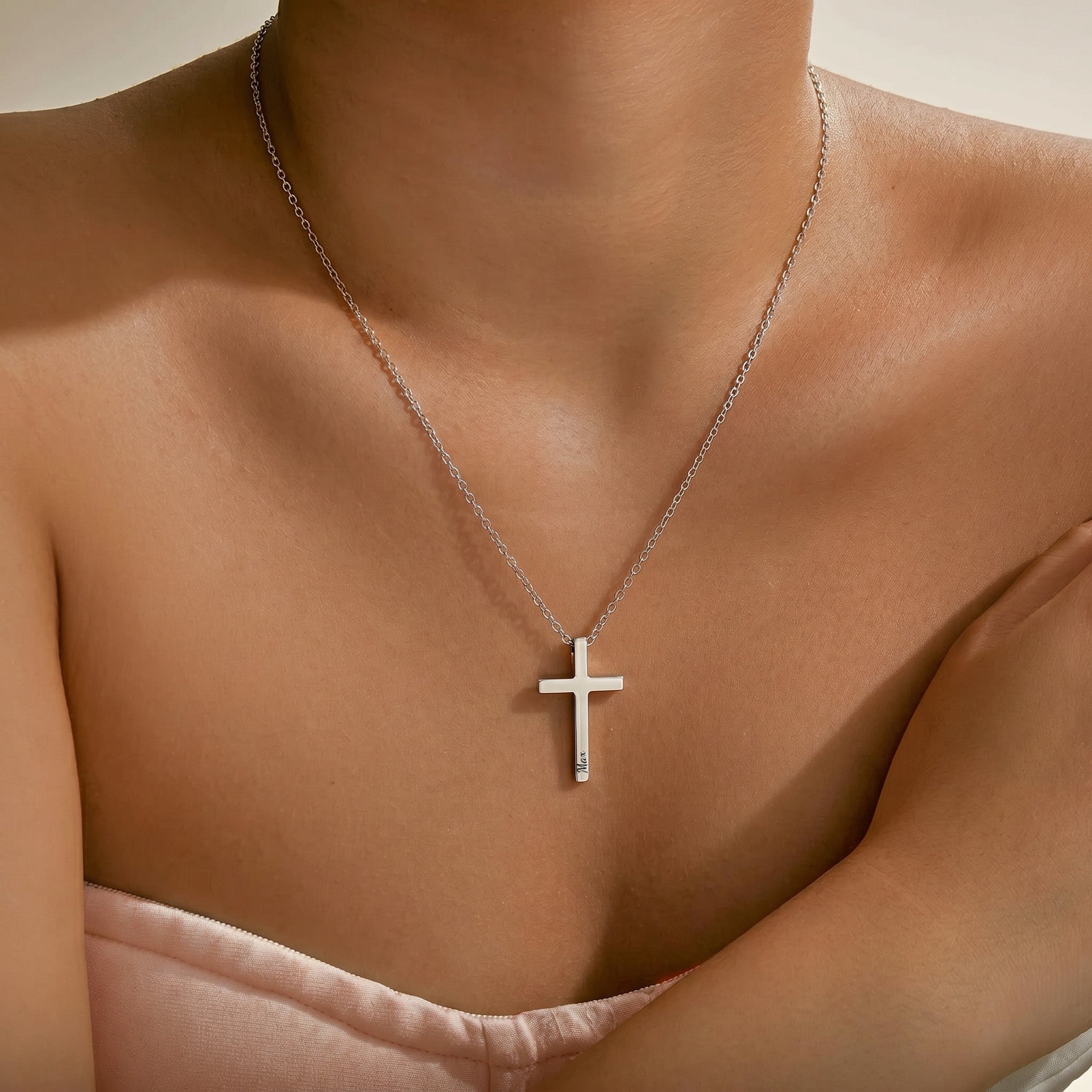 Woman wearing rhodium silver cross necklace with pet name