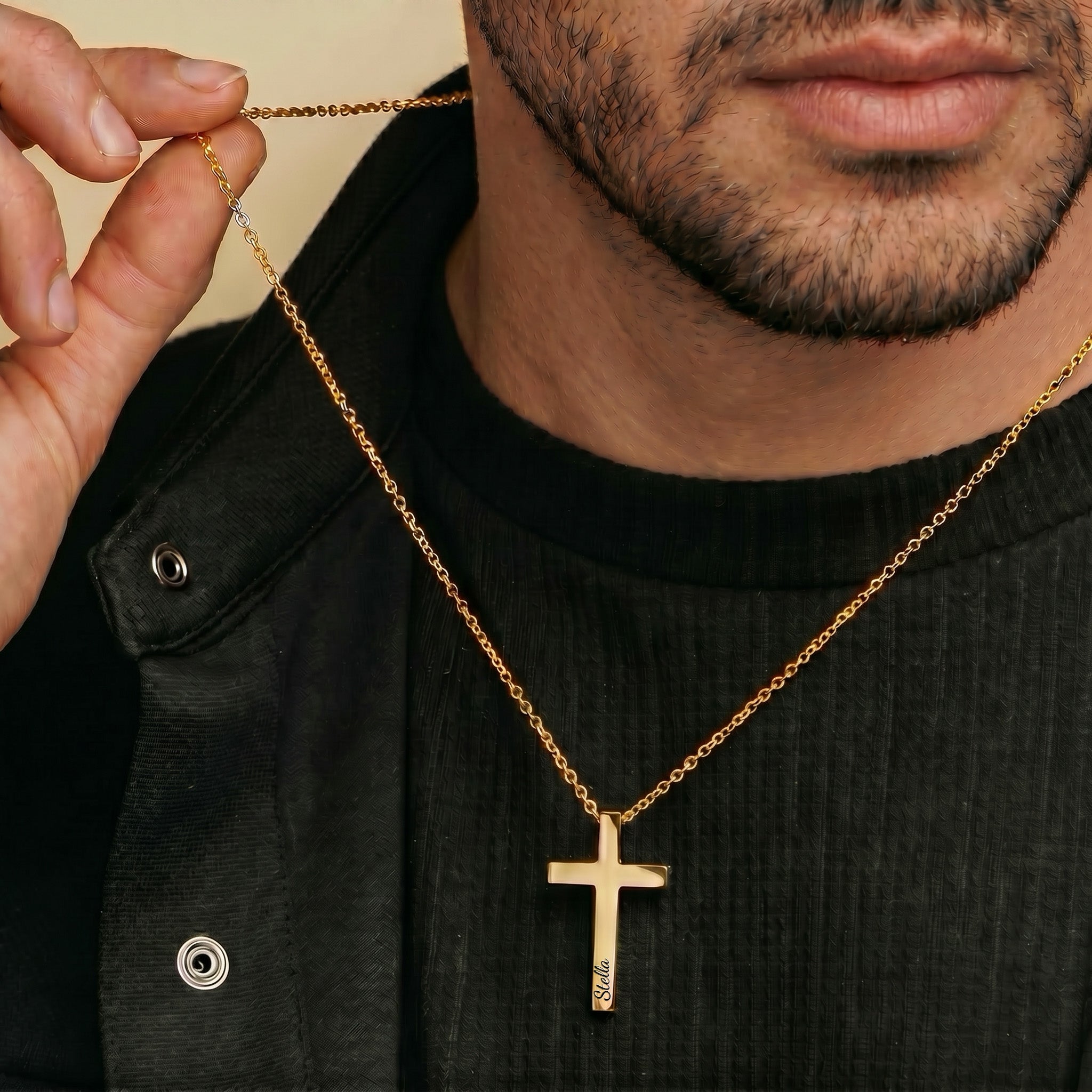 Man wearing 18K gold cross necklace with pet name over black jacket