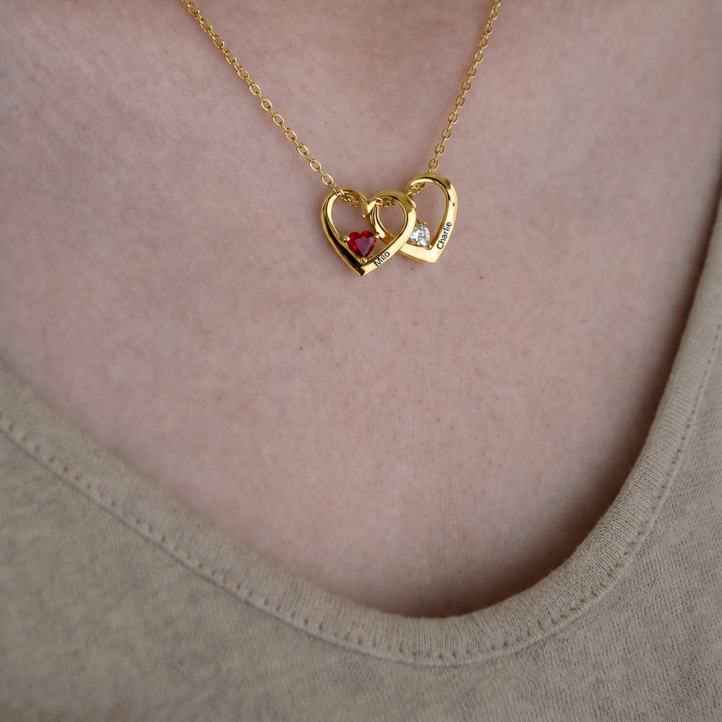 18K gold heart birthstone necklace worn, two hearts with engraved pet names and birthstones