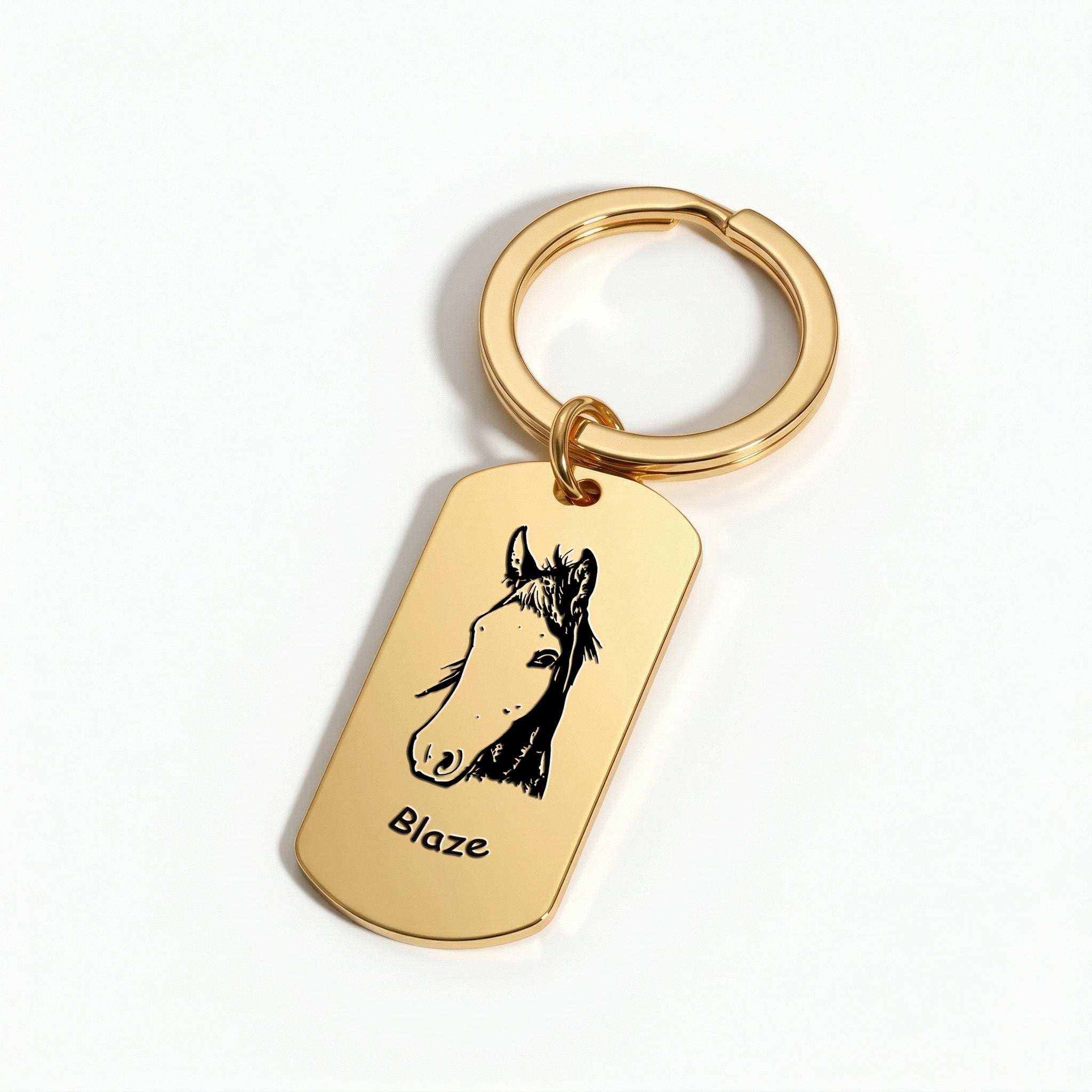 18K gold pet portrait dog tag keychain flat-lay on softly lit white surface, editorial product detail