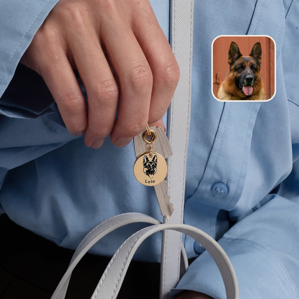 18k yellow gold pet face keychain held in hand showing portrait detail