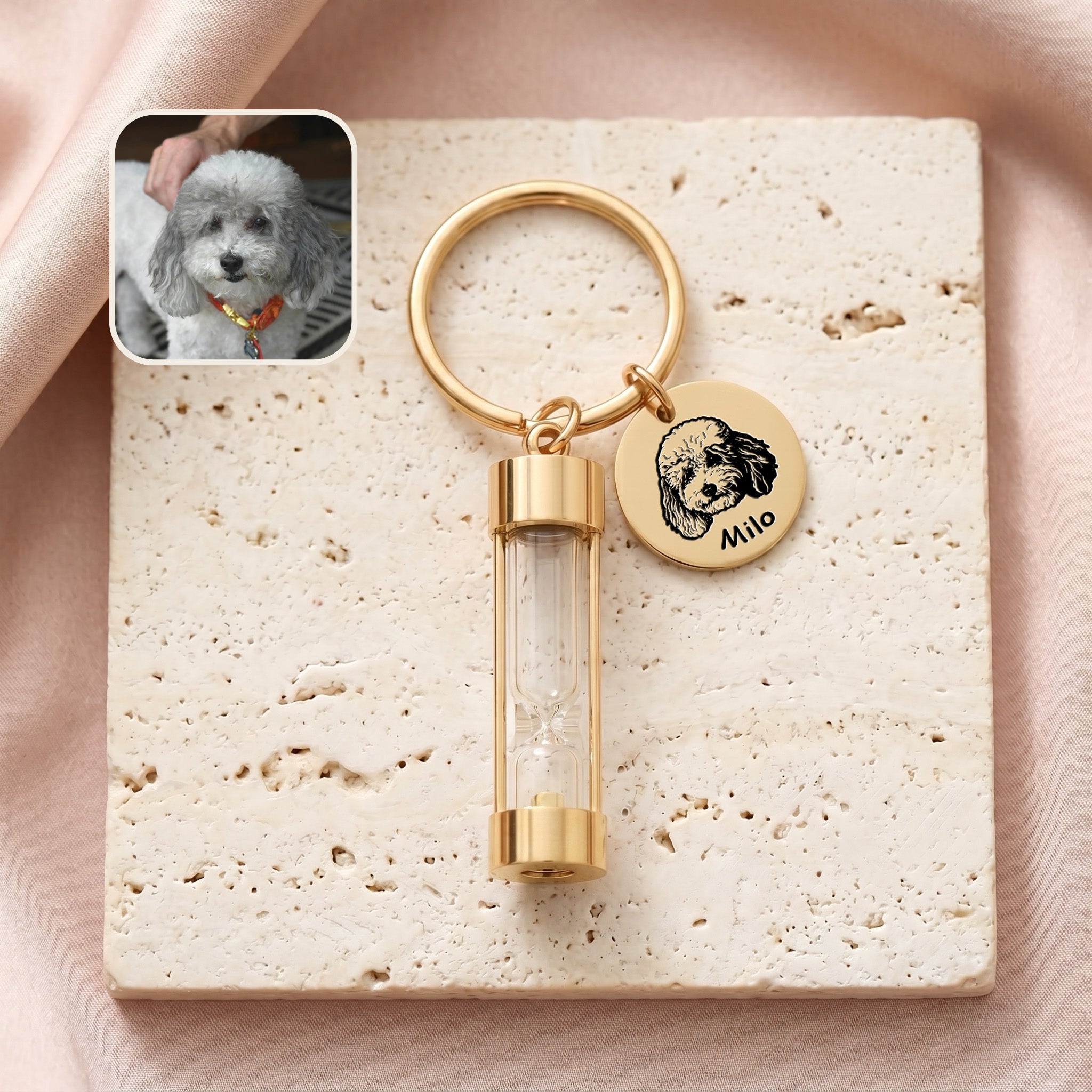 18k gold-plated pet portrait hourglass keychain on travertine stone with engraved poodle portrait disc and glass hourglass urn, with reference photo inset