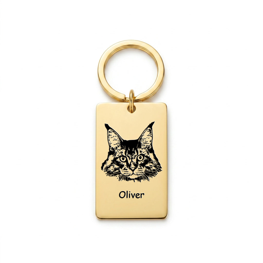 18k gold pet portrait plate keychain on white background, Maine Coon cat portrait and name 'Oliver' laser-engraved on the rectangular plate