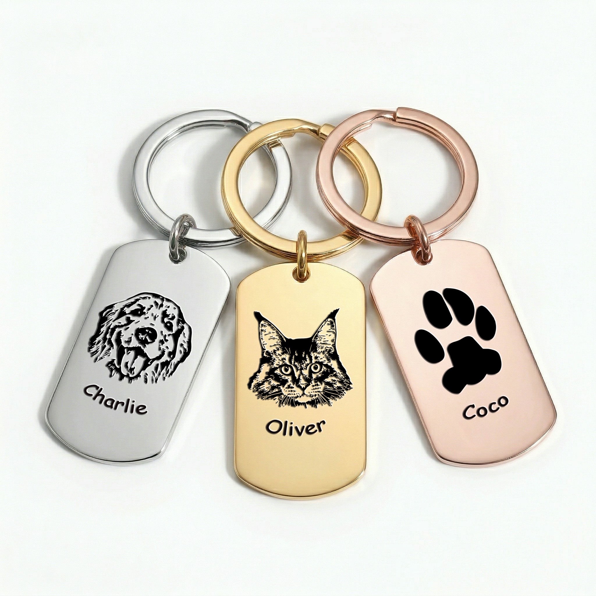 Three pet portrait dog tag keychains shown in rhodium silver, 18K gold, and 18K rose gold plating finishes side-by-side on white background