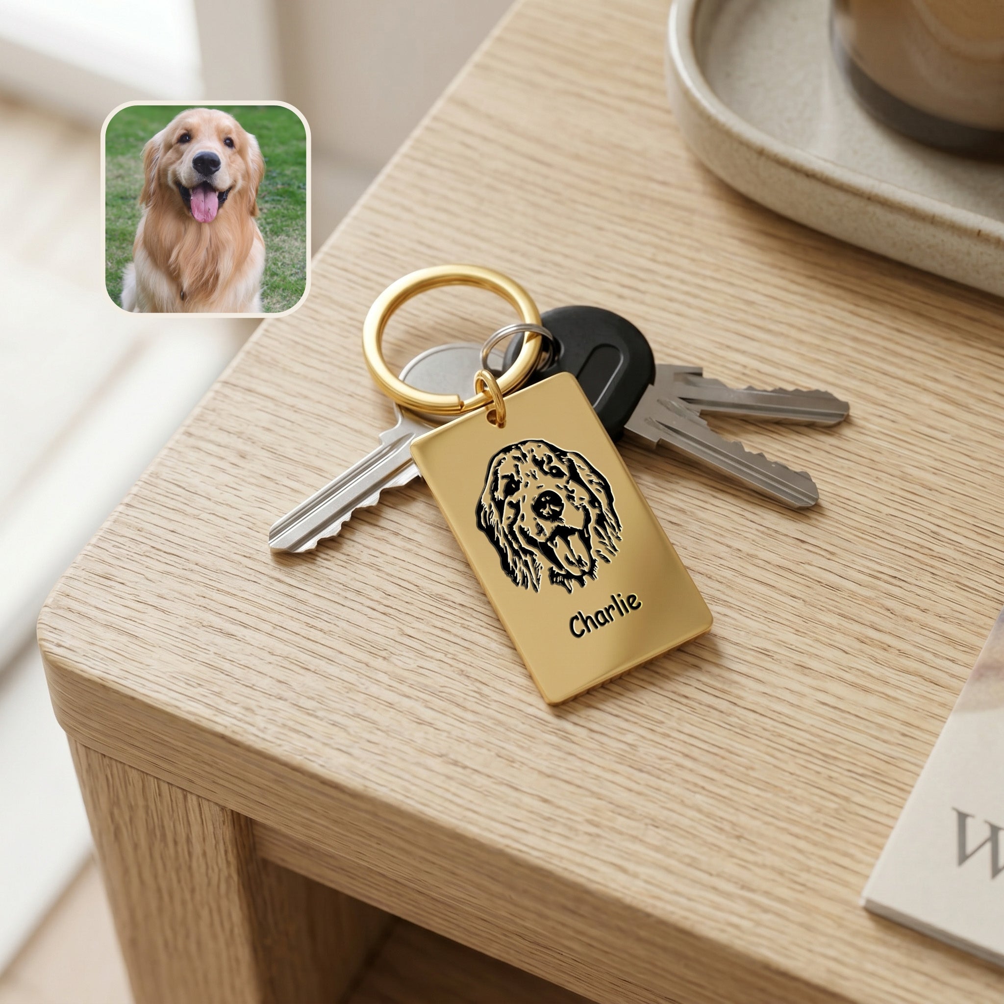 18k gold pet portrait plate keychain on a wooden desk beside keys, dog reference photo inset showing the portrait match