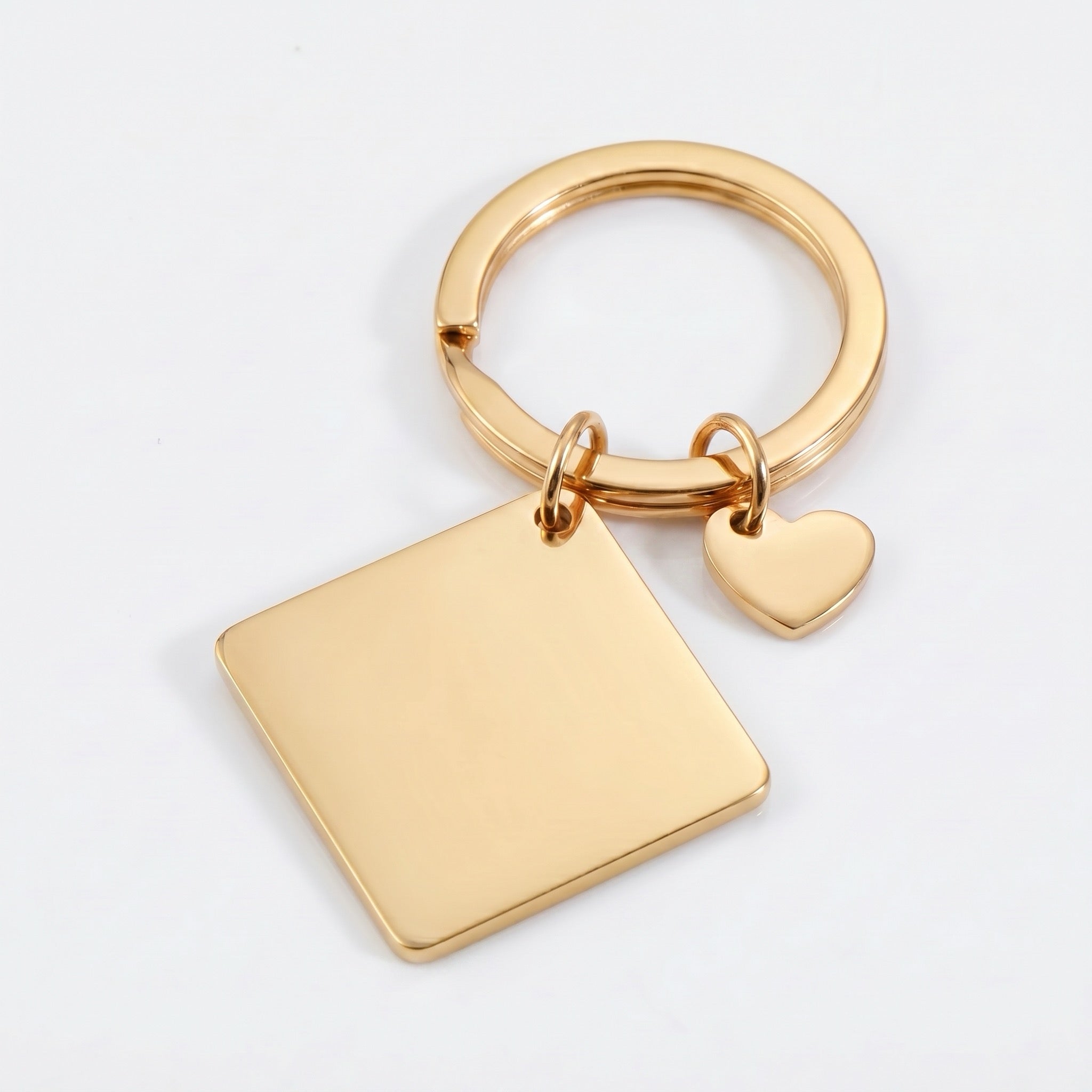 18k gold pet portrait square keychain flat lay showing polished square plate and heart charm
