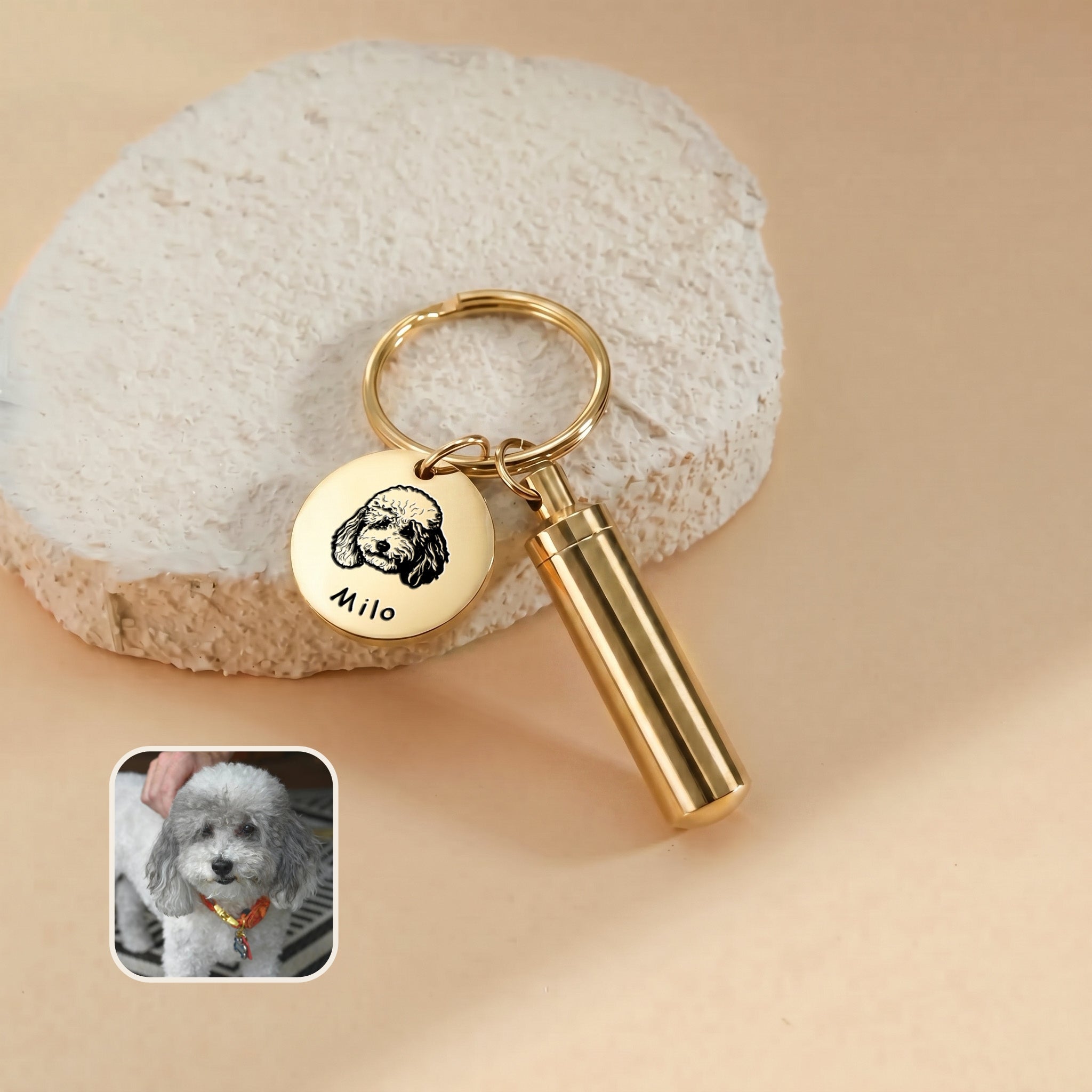 18k gold-plated pet portrait and ashes cylinder keychain close-up &mdash; engraved disc with hand-drawn portrait and the name Milo beside the cylinder urn, with a reference photo inset