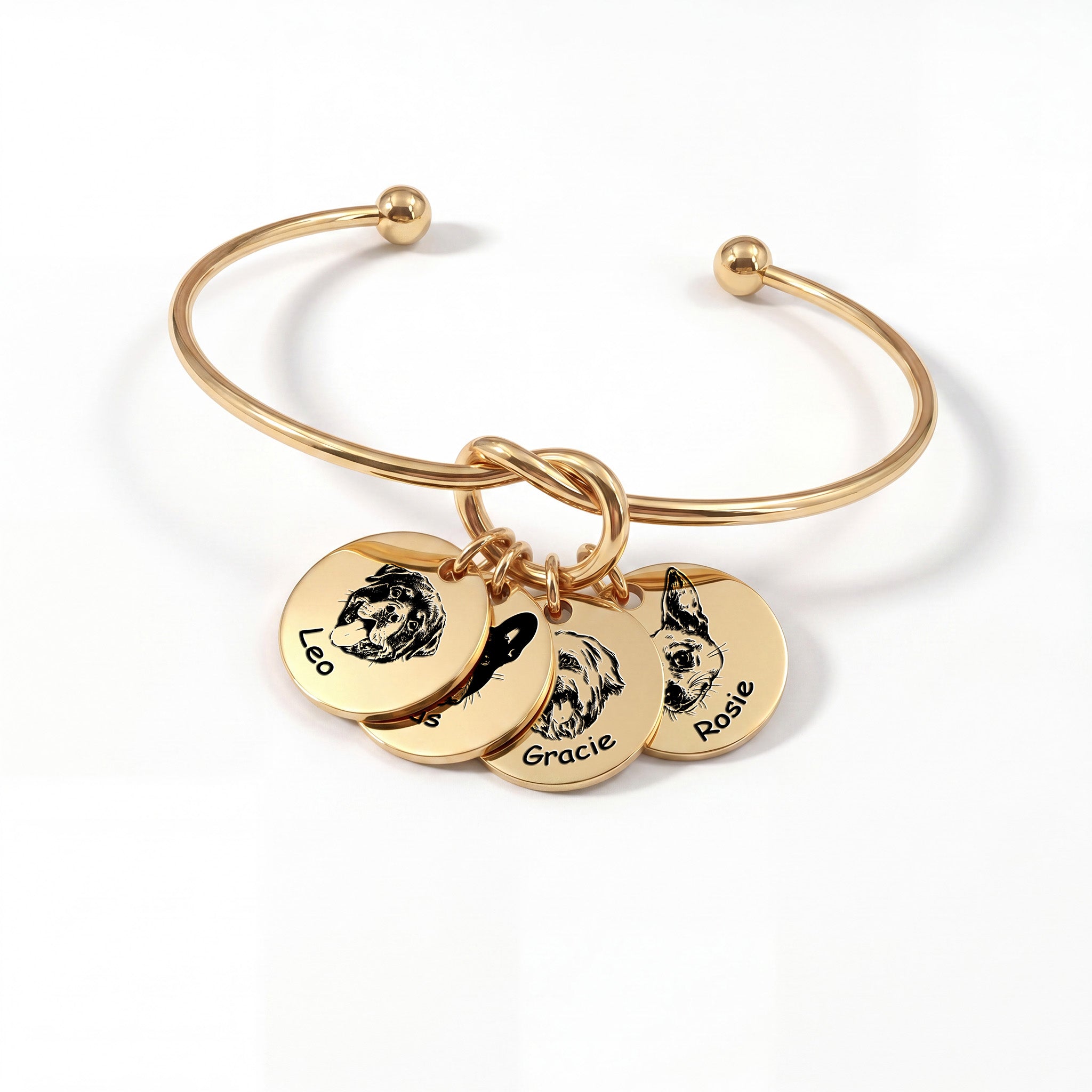 Gold knot cuff bracelet with four engraved pet portrait disc charms on a white background
